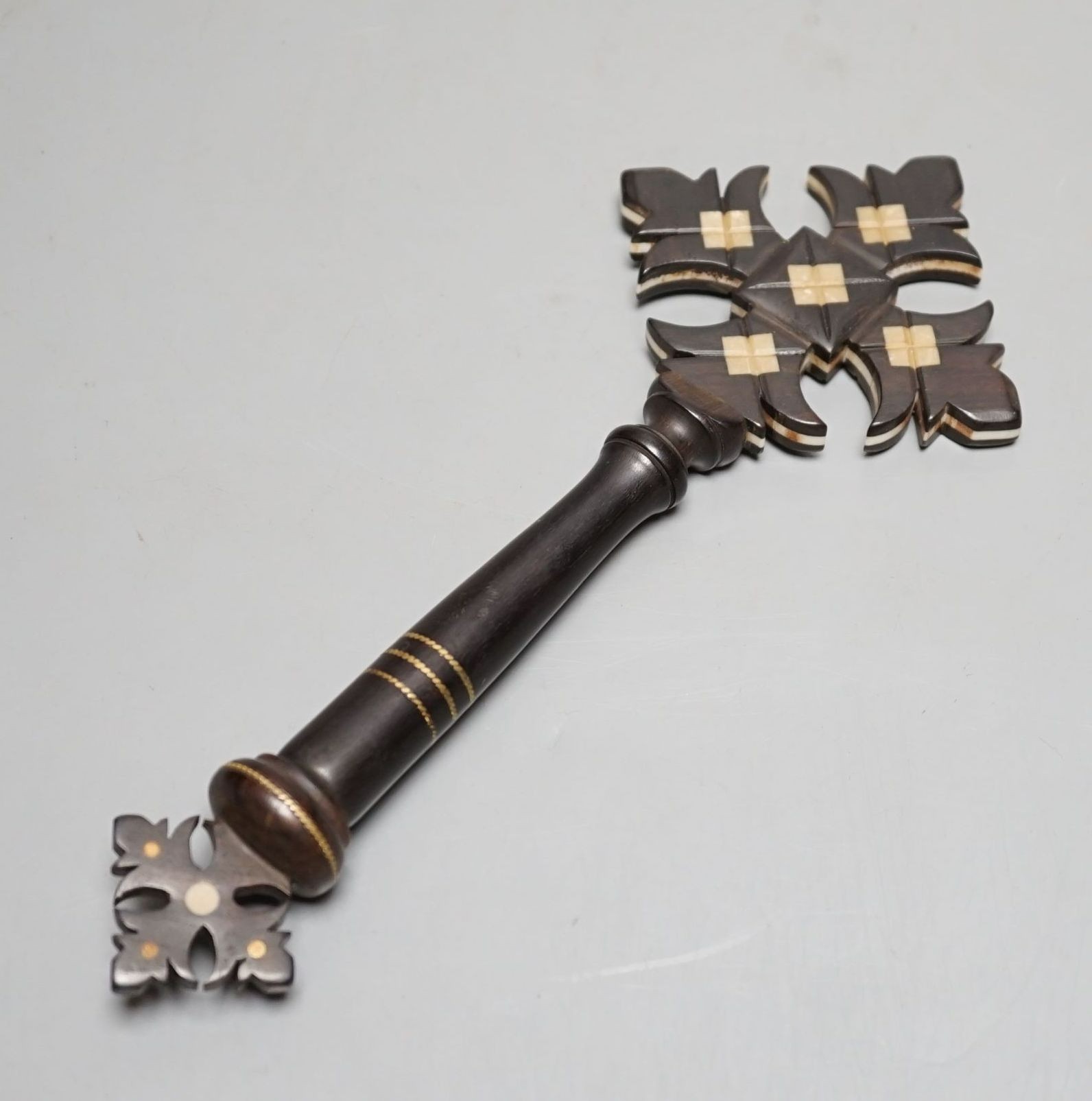 An ebony and ivory cross with holy water compartment, 25 cms long.